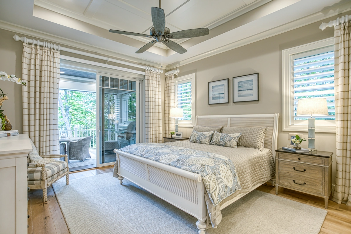 bedroom with king size bed, end tables, chair, sliding glass doors leading to outdoor deck